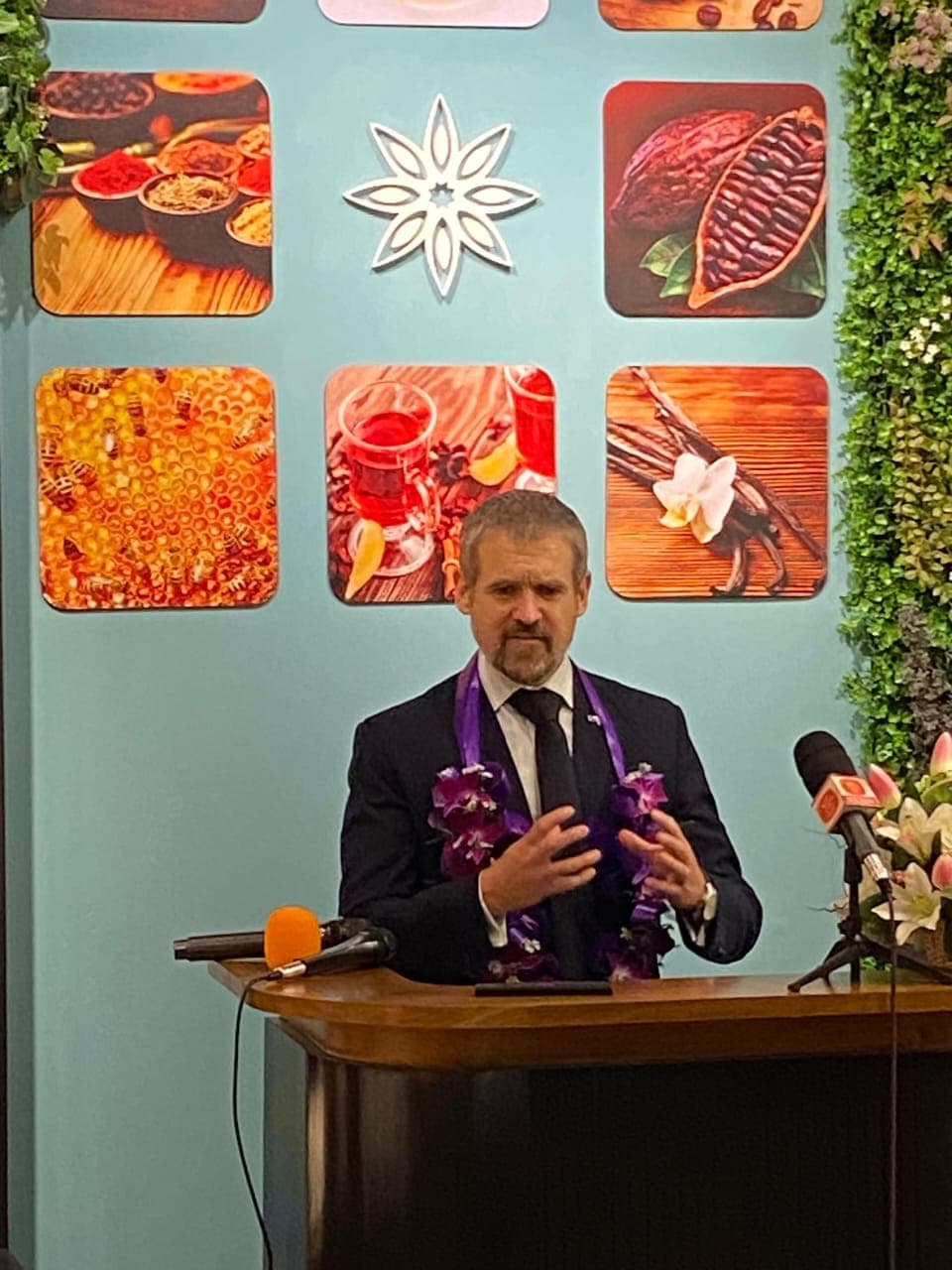 A guest speaks at a podium in front of a Knuckles Valley display.