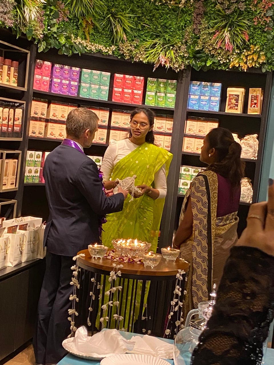 Guests talk beside shelves and a display table inside Knuckles Valley.