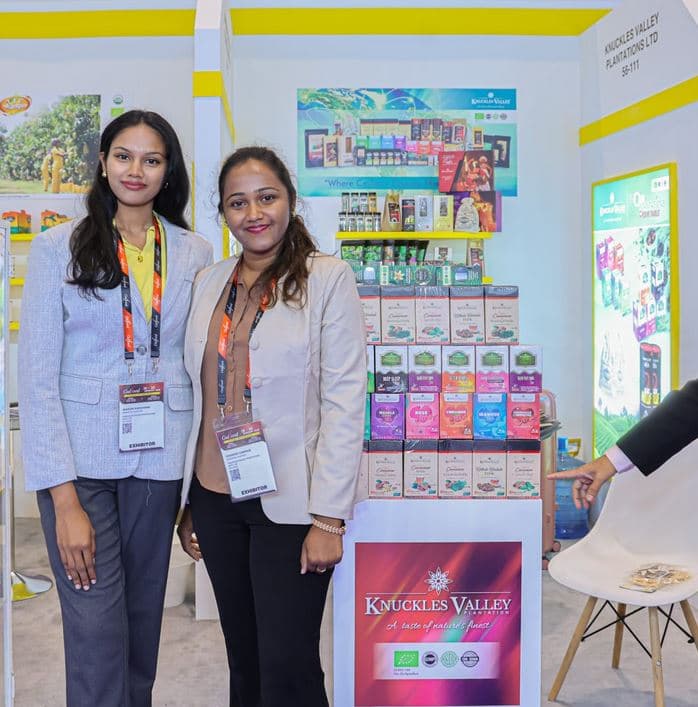 Two women stand beside a Knuckles Valley display at Gulfood 2026.