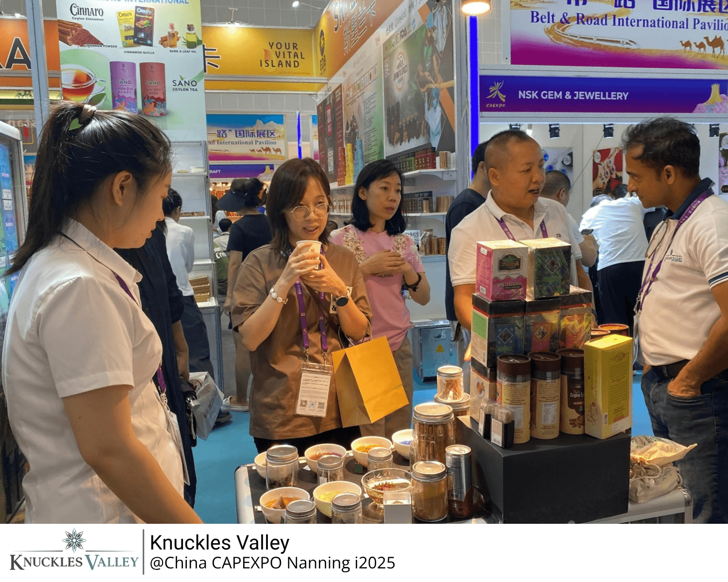 Visitors speak with representatives beside the Knuckles Valley product display in Nanning.