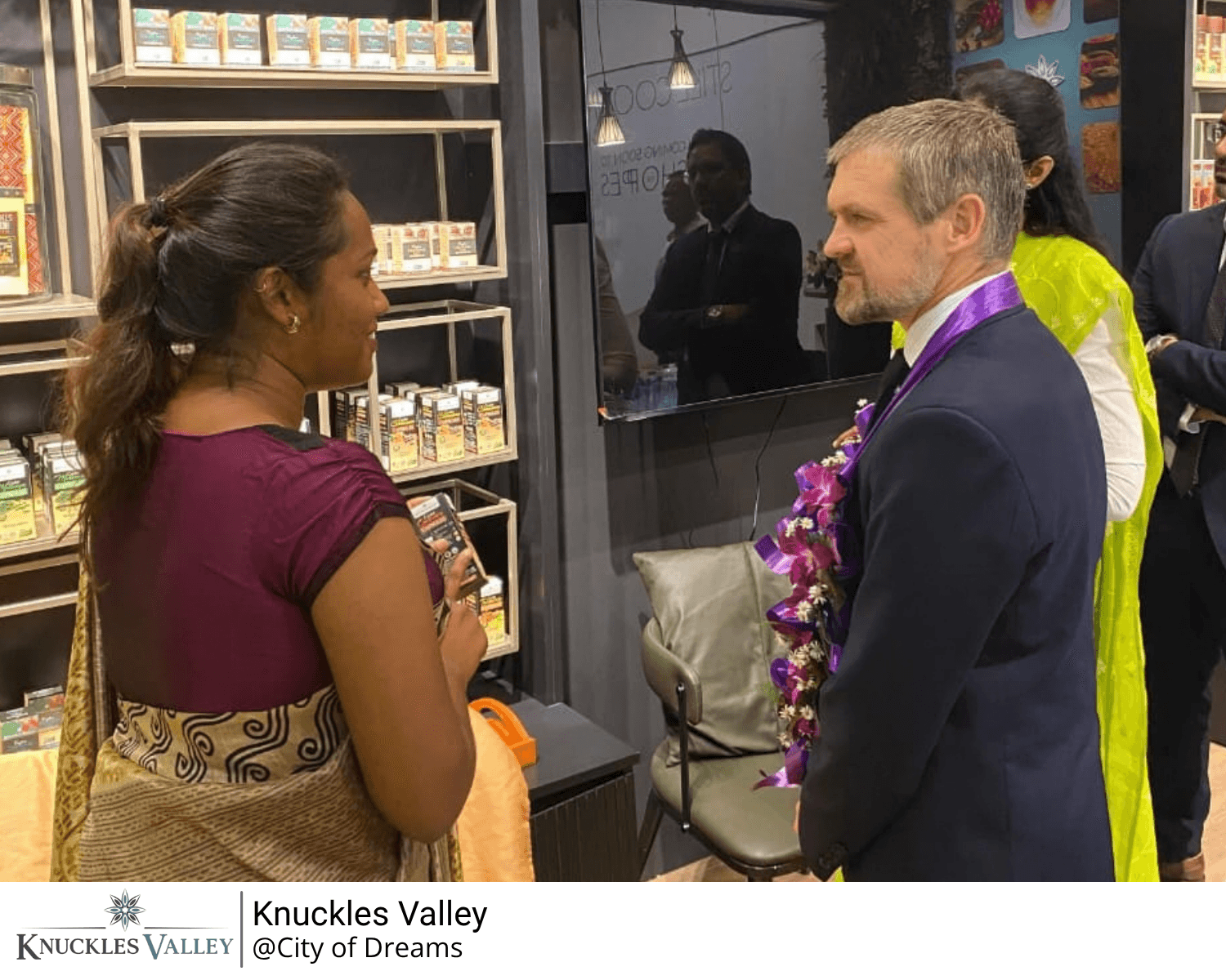 Two guests converse near the entrance of the Knuckles Valley store.