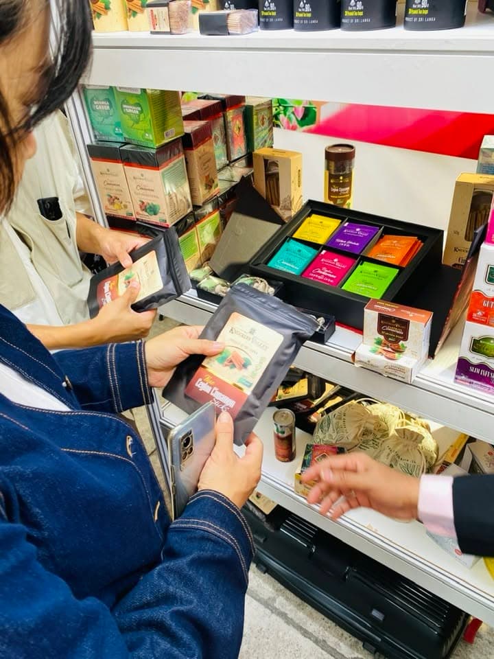 A visitor looks closely at Knuckles Valley packaging beside the product shelves.