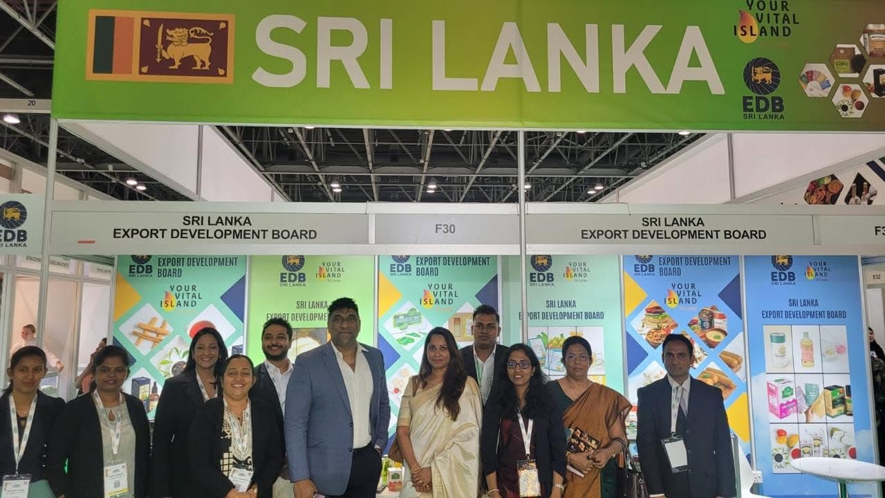 A group stands beneath the Sri Lanka sign at the Organic & Natural exhibition.