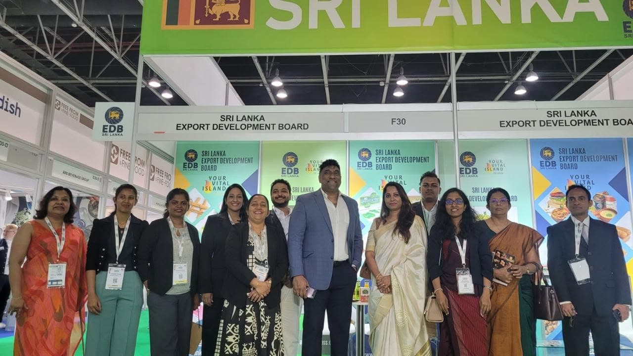 Visitors and exhibitors pose together in front of the Sri Lankan stand in Dubai.